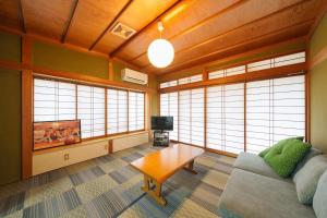 a living room with a couch and a coffee table at 民泊ａｉｋｏ in Fukushima