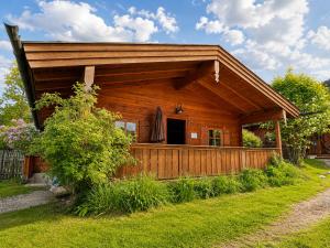 a log cabin with a porch and a fence at Chalets mit Schlierseeblick, neue Küche neues Bad in Schliersee +17 photos