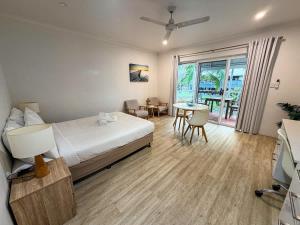 a bedroom with a bed and a table and chairs at U222 - The Serenity in Eimeo