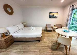 a bedroom with a bed and a table and a table at U222 - The Serenity in Eimeo