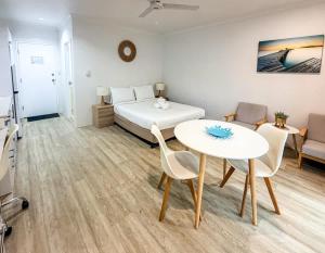 a bedroom with a bed and a table and chairs at U222 - The Serenity in Eimeo