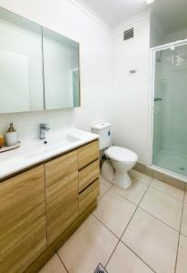 a bathroom with a toilet and a sink and a shower at U222 - The Serenity in Eimeo +7 photos