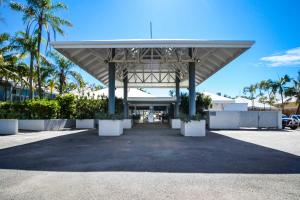 a large pavilion with palm trees in a parking lot at U240 Dhr in Eimeo