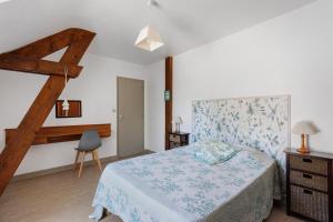 a bedroom with a large bed and a ladder at Le Vallon in Mondion +24 photos