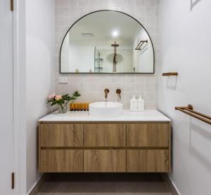 a bathroom with a sink and a mirror at Belle Vue - 4brm 2bth AC Pool Views in Eimeo