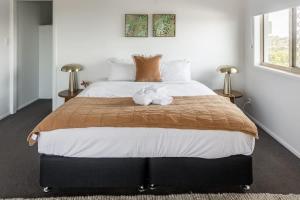 a bedroom with a large bed with two flowers on it at Belle Vue - 4brm 2bth AC Pool Views in Eimeo +16 photos