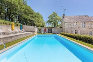 a swimming pool in the backyard of a house at Le Vallon in Mondion