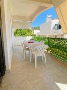 a patio with a table and chairs on a balcony at Peaceful Seaside Apartments in Vaia
