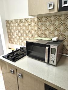 a microwave oven sitting on top of a kitchen counter at Gamma Group Sud in Bucharest