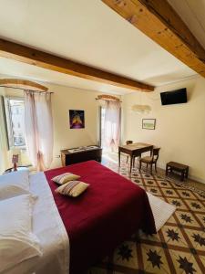 a bedroom with a large bed and a desk at La Terrazza Sul Monte in Monte San Savino
