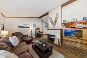 a living room with a couch and a fireplace at Cozy Pines & Paths Retreat in South Lake Tahoe