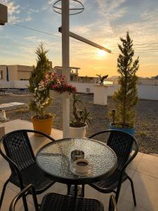 a table and chairs with a coffee cup on a patio at Hersol Skyline in Durrës