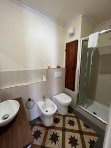 a bathroom with a sink and a toilet and a shower at La Terrazza Sul Monte in Monte San Savino