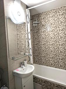 a bathroom with a sink and a toilet and a mirror at Gamma Group Sud in Bucharest +6 photos