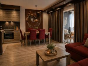 a living room with a dining table and a kitchen at Johanan 2 in Makarska