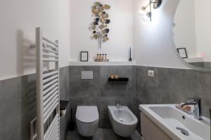 a bathroom with a toilet and a sink and a mirror at BF Glam-Apartments in Perugia +27 photos