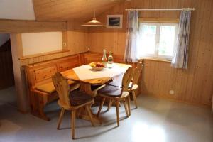 a dining room with a table and chairs and a window at Haus Danna in Sankt Gallenkirch +50 photos