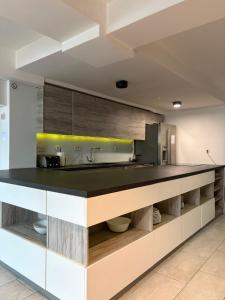 a kitchen with a large black counter top at VilaMihaela in Skopje
