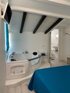 a room with a bed and a tv on the wall at Civico36 in Ilbono +68 photos