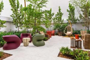a patio with colorful chairs and tables at Domus Brickell Park in Miami +15 photos