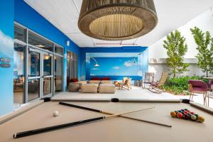 a pool table in a living room with blue walls at Domus Brickell Park in Miami