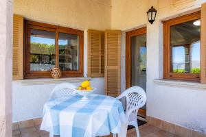 a table with a bowl of fruit sitting on a porch at Can Figó in Alcudia