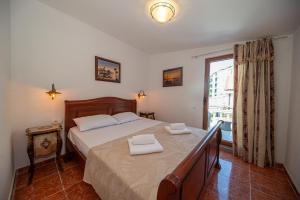 a bedroom with a bed with two towels on it at Perfect Seaview Two-bedroom Apartment Tramontana in Dobra Voda