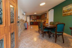 a kitchen and dining room with a table and chairs at Perfect Seaview Two-bedroom Apartment Tramontana in Dobra Voda +53 photos