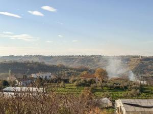 a view of a field with smoke in the distance at Dimora Fonte Grande in Lanciano