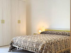a bedroom with a bed with a patterned bedspread at Dimora Fonte Grande in Lanciano