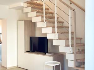 a living room with a staircase with a tv at Dimora Fonte Grande in Lanciano