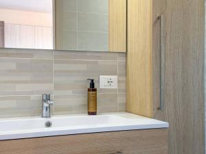 a bathroom sink with a soap dispenser on it at Dimora Fonte Grande in Lanciano +19 photos