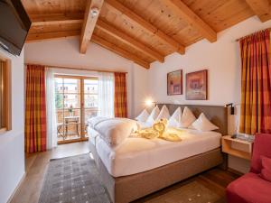 a bedroom with a large bed in a room at Hotel Theresia Garni in Sankt Johann in Tirol +57 photos
