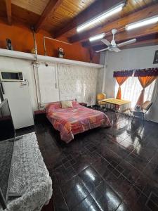 a bedroom with a bed and a table in it at Guiñazú in Junín