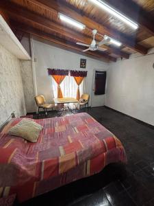 a bedroom with a large bed with chairs and a table at Guiñazú in Junín