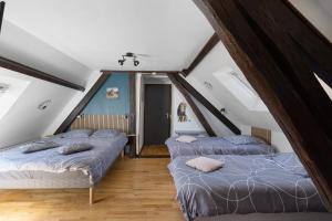 a attic room with three beds in it at La Ferme Des Bigornes in Châtillon-sur-Indre +65 photos