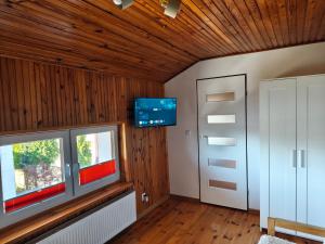 a room with a door and a tv on the wall at Willa 2 piętro in Szczecinek