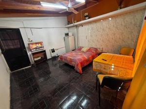 a bedroom with a bed and a table and a tv at Guiñazú in Junín