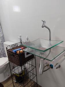 a bathroom with a glass table and a sink at Espaçoso para casais in Vila Velha +26 photos