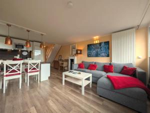 a living room with a couch and a table at Chalet Platzhirsch in Braunlage
