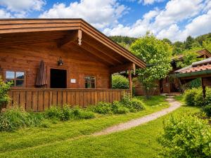 a log cabin with a path in front of it at Chalets mit Schlierseeblick, neue Küche neues Bad in Schliersee