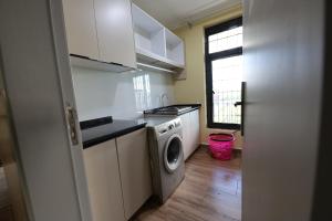 a kitchen with a washing machine and a washer at Shamba la Chini in Nairobi