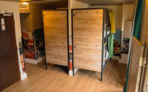 a pair of wooden doors in a room at a&o London Docklands Riverside in London