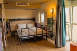 a bedroom with a bed in a room at a&o London Docklands Riverside in London