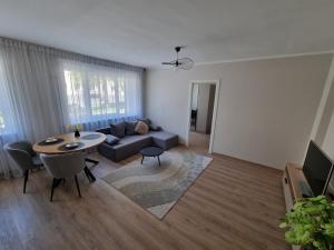 a living room with a couch and a table at Hubane korter Paalalinnas in Viljandi +2 photos