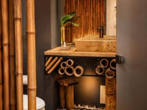 a bathroom with a sink and a toilet with bamboo at Zen Hotel Boutique in Bogotá +39 photos