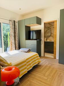 a bedroom with a bed with a yellow and white stripes at CANNES Maison Design "DOLCE VITA" in Cannes