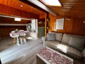 a living room with a couch and a table at Atico de madera Apartamento en Rinlo, RIBADEO in Ribadeo