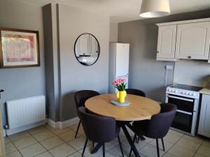a kitchen with a table and chairs in a kitchen at Willow House in Newtownshandrum