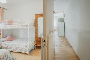a room with two bunk beds and a hallway at Pisito del Pueblo in Navaluenga